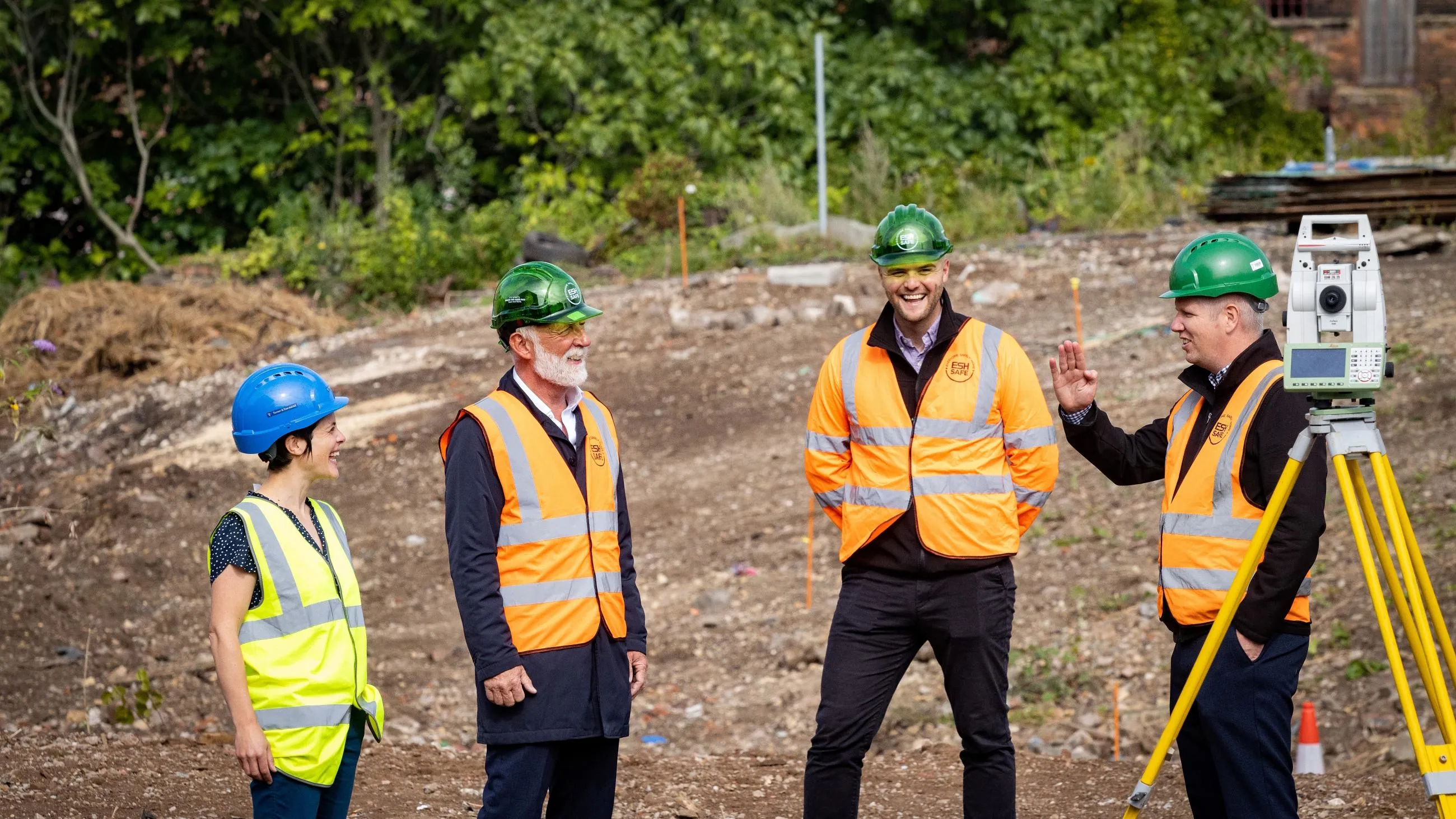 Four colleagues in high-vis standing in a construction site